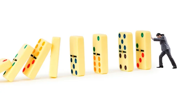 Empresário e dominós isolados no branco — Fotografia de Stock