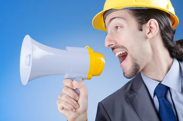 Construction worker shouting via loudspeaker — Stock Photo, Image