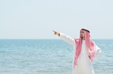 Arab on seaside in traditional clothing