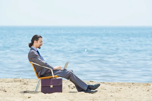 stock image Businessman working on laptop on seaside