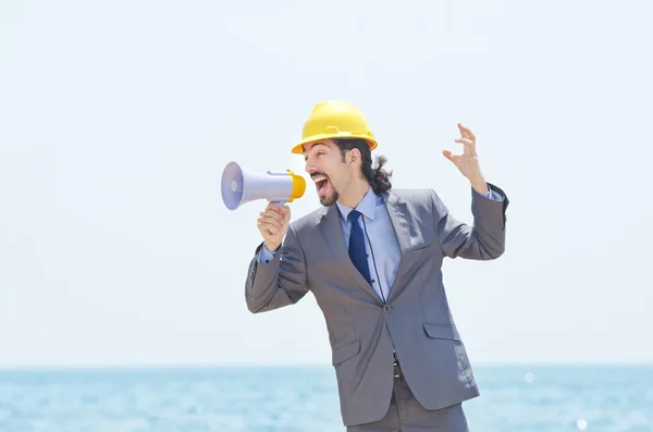 stock image Man wearing helmet speaks with megaphone