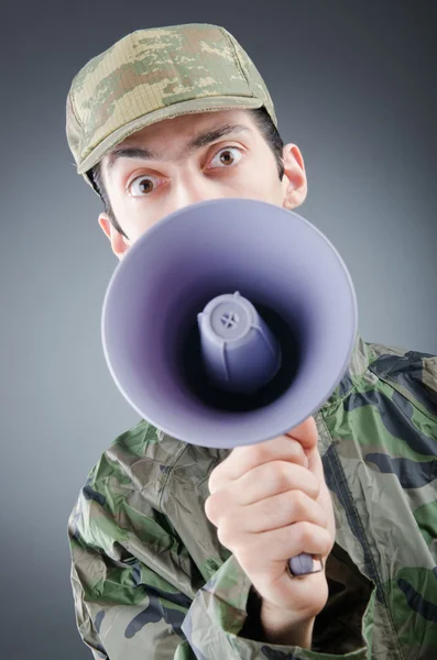 Soldier with loudspeaker shouting — Stock Photo, Image