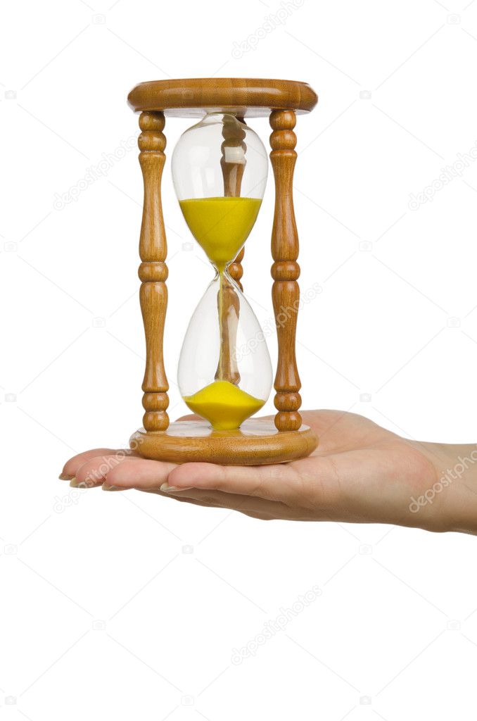 Hand holding hourglass on white