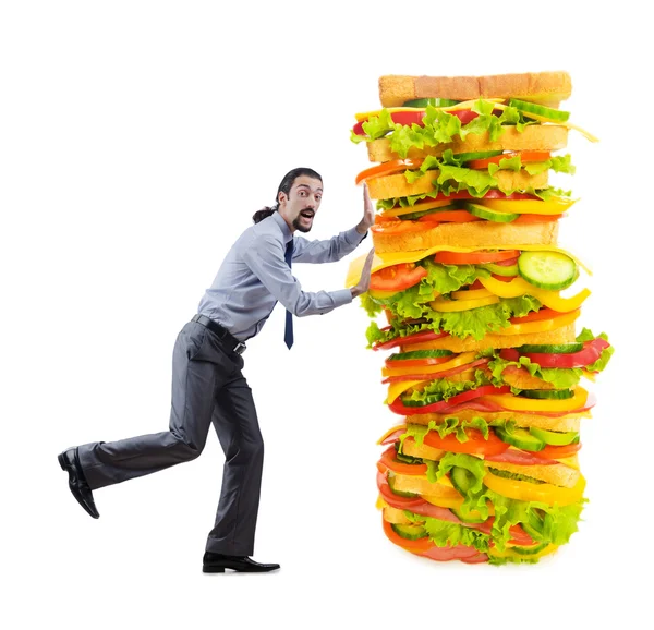 Человек и гигантский сэндвич на белом — стоковое фото