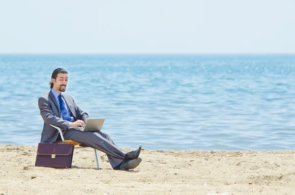 stock image Businessman working on laptop on seaside