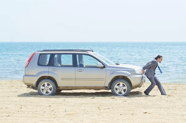 Man with car on seaside — Stock Photo, Image