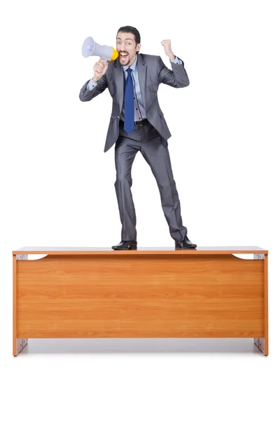 Businessman with loudspeaker at the desk — Stock Photo, Image