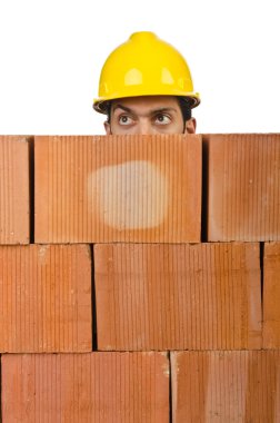 Businessman with bricks on white