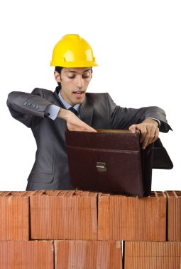 Businessman with bricks on white