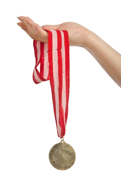 Hand holding gold medal on white — Stock Photo, Image