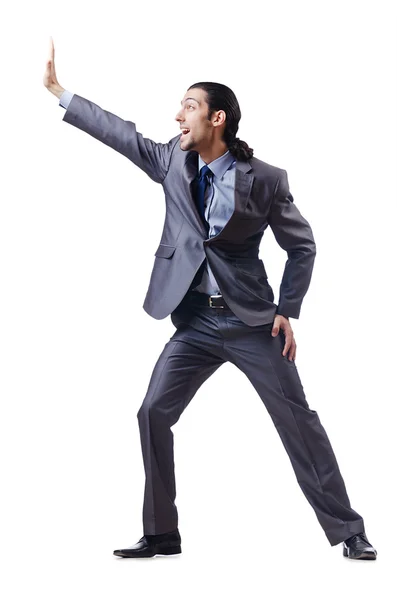 Young businessman pushing invisible obstacles — Stock Photo, Image