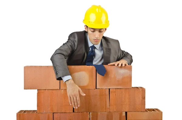 Businessman with bricks on white Stock Picture