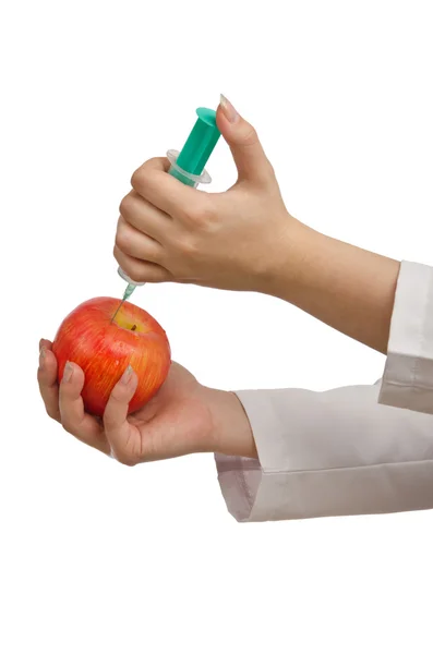 Experiment with apple and syringe on white — Stock Photo, Image