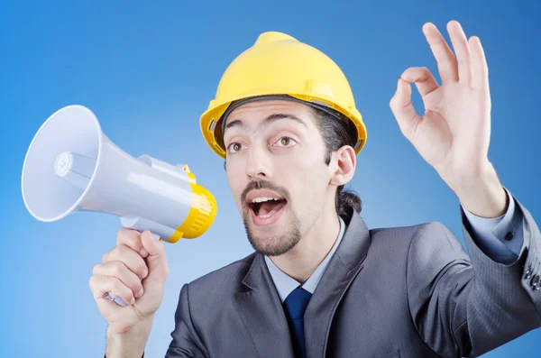 Construction worker shouting via loudspeaker — Stock Photo, Image