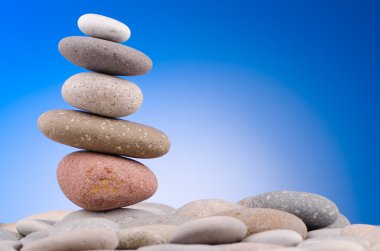 Pebbles stack against gradient background clipart