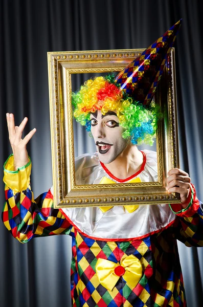 Clown met afbeeldingsframes in studio — Stockfoto