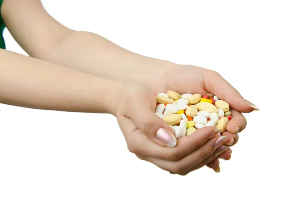 Hände, die Pillen auf weiß halten — Stockfoto