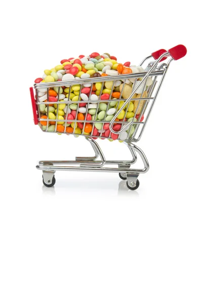 Carrito de compras con muchas píldoras de colores — Foto de Stock