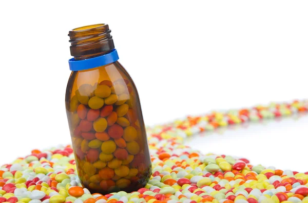 Bottle with many colourful pills — Stock Photo, Image