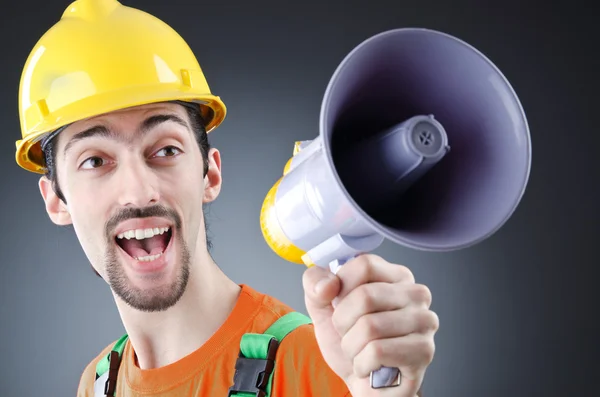 Construction worker with loudspeaker in studio — Stock Photo, Image
