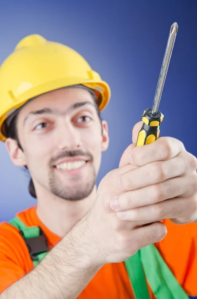 Man with a screwdriver in studio — Stock Photo, Image