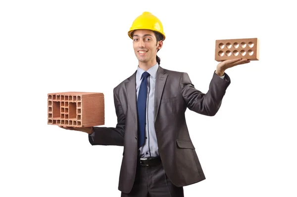 Businessman with bricks on white — Stockfoto