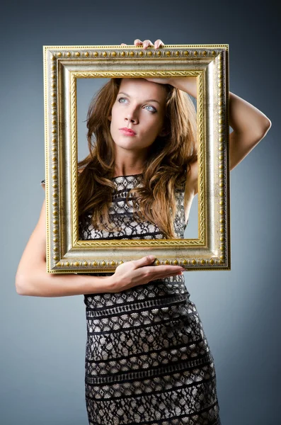 Young woman with picture frame on white — Stock Photo, Image