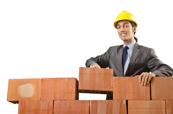 Businessman with bricks on white Stock Picture