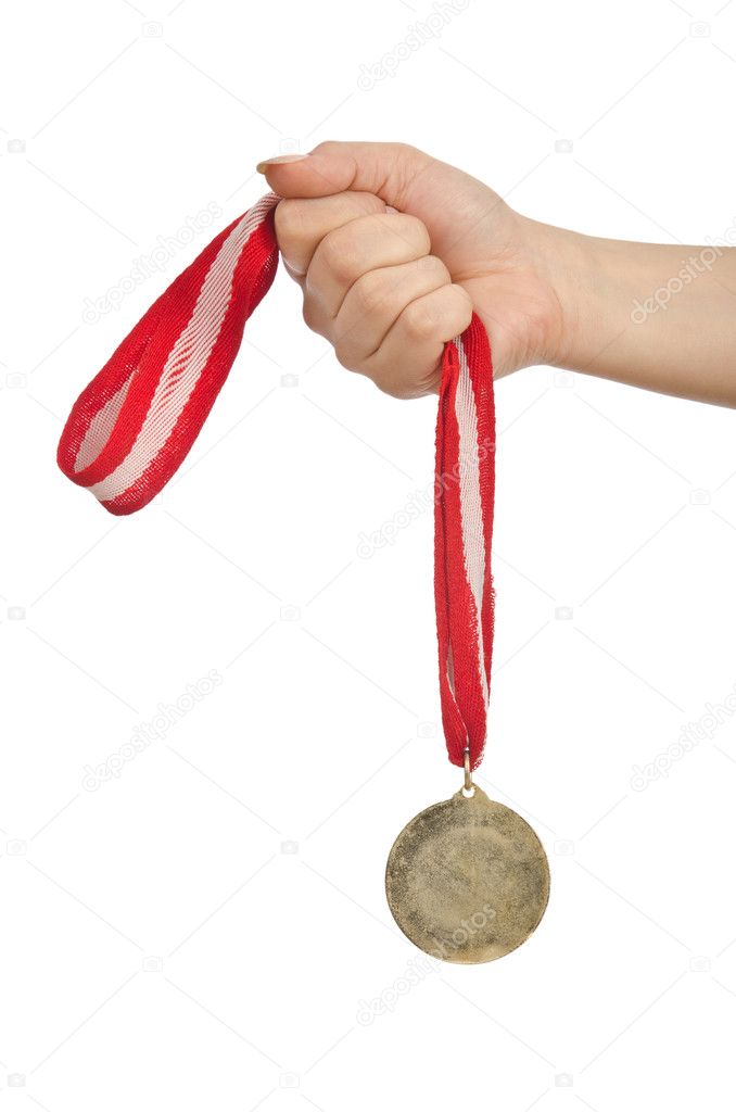 Hand holding gold medal on white