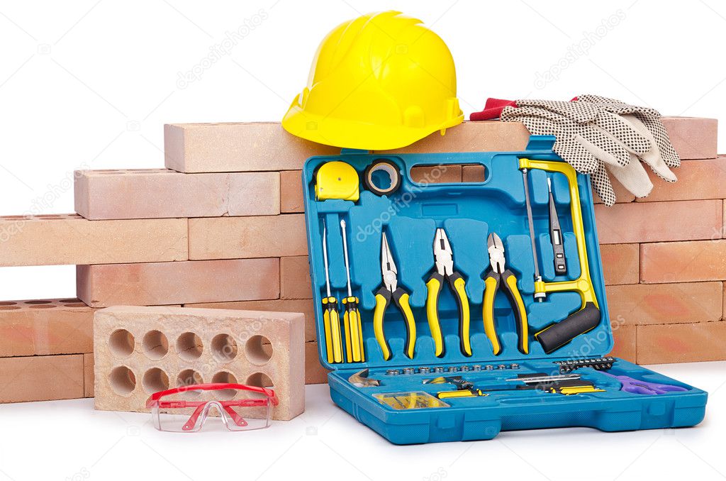 Construction concept with helmet and toolkit