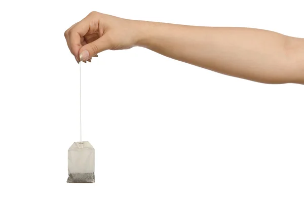 Mână care ține teabag pe alb — Fotografie, imagine de stoc