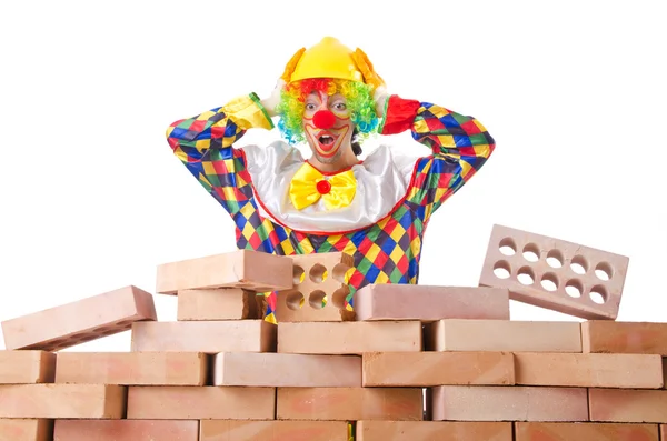 Bad construction concept with clown laying bricks — Stock Photo, Image