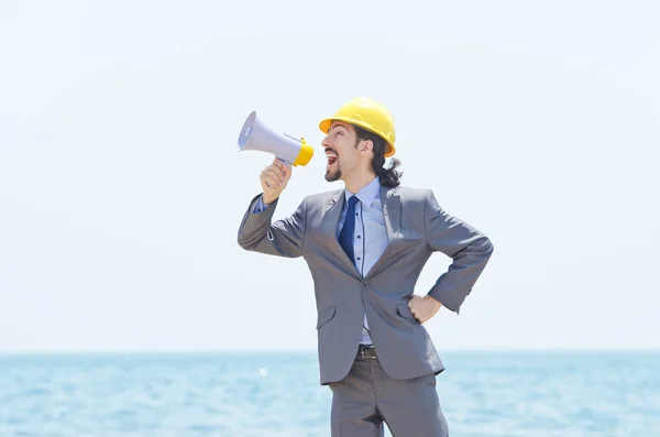 stock image Man wearing helmet speaks with megaphone