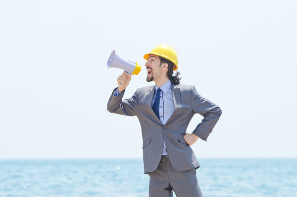Man wearing helmet speaks with megaphone