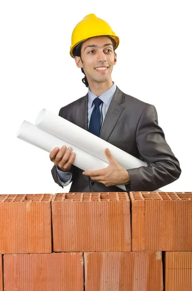 Бизнесмен с кирпичами на белом — стоковое фото