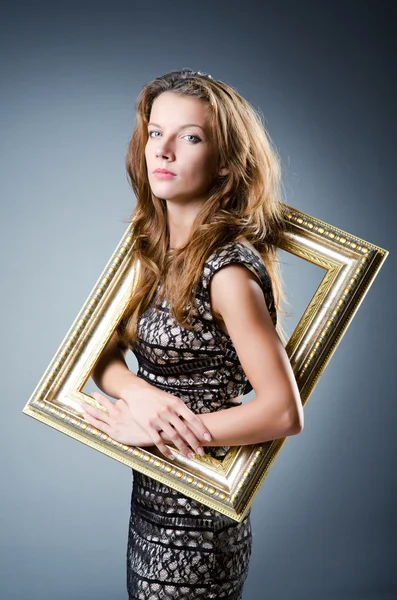 Young woman with picture frame on white — Stock Photo, Image