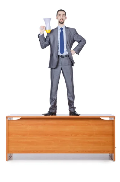 Uomo d'affari con altoparlante alla scrivania — Foto Stock