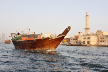 The bows of traditional wooden trading dhows moored in Dubai Creek, UAE. clipart