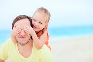 Father and daughter at beach clipart