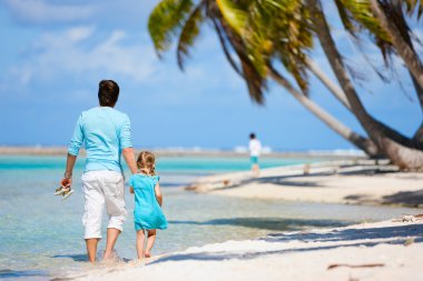 Father and daughter on a beach clipart