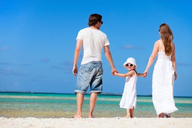 Happy family on tropical vacation clipart