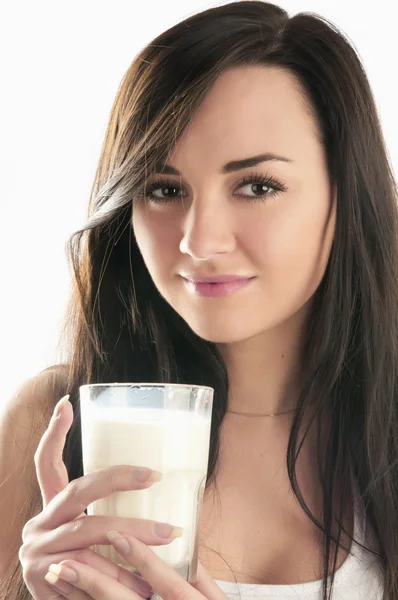 stock image Happy young female holding a glass of milk