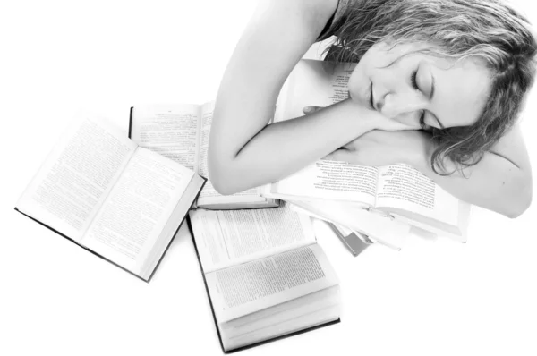Young woman sleeping on stack of books — Stock Photo, Image