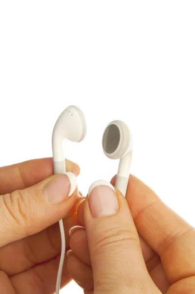Bílá sluchátka v ruce izolovaných na bílém — Stock fotografie