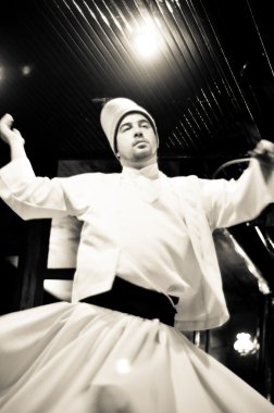 ISTANBUL, TURKEY - June 03: Whirling dervish dancing in Café Meşale on June 03, 2012 in Istanbul, Turkey. Sufi whirling is a form of Sama or physically active meditation practiced by Sufi Dervishes.
