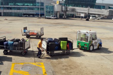 ISTANBUL, TURKEY - JUNE 06: Loading platform and carts in Istanbul Ataturk Airport on June 06, 2012 in Istanbul, Turkey. clipart