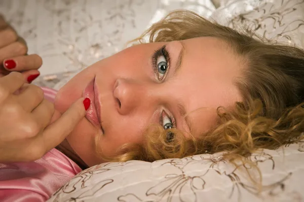 Aantrekkelijke blonde liggend op het bed — Stockfoto