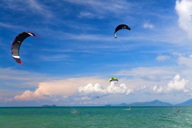 Wakeboarders jumping from water in open sea clipart