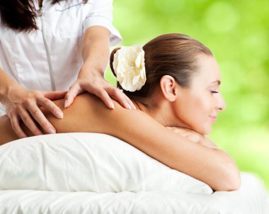 Beautiful woman at massage procedure clipart