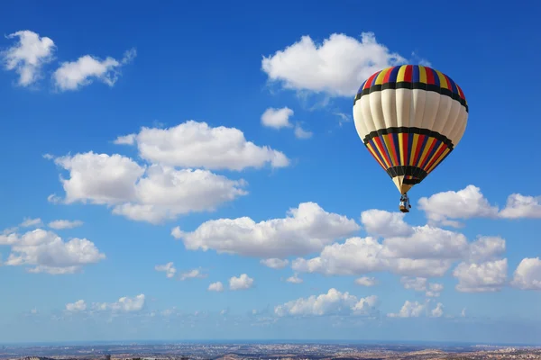 Huge air balloon flying in the cloudy sky — Stock Photo, Image